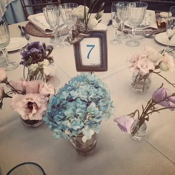 Mesa de boda con centro de hortensias y número de mesa